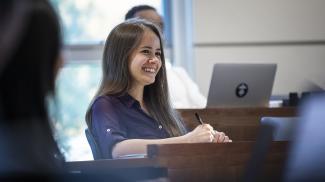 Student in Isenberg School of Management classroom.