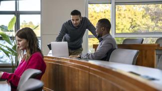 Three people in a classroom